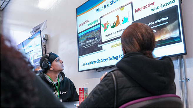 Students looking up at a TV screen