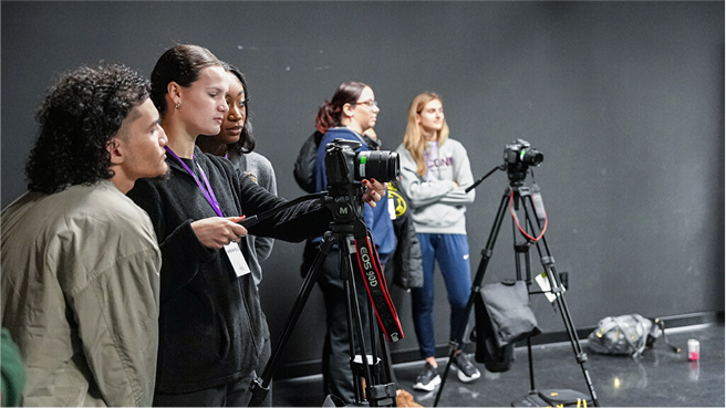 Group of film students with cameras in a mocap filming studio